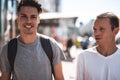 Optimistic friends speaking during sunny walk outdoor