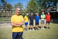 Portrait of beaming senior man on football field