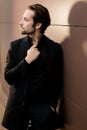 Portrait of beard caucasian man looking at the side, wearing formal classic suit. Handsome business man standing outside