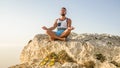 Portrait of bearded adult man making lotus pose