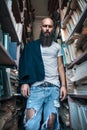 Portrait of bearded alone hipster man in library