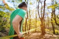 Portrait of a bearded athletic man engaged in slack next to a stretched sling for balance in the autumn forest. back Royalty Free Stock Photo