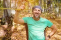 Portrait of a bearded athletic man engaged in slack next to a stretched sling for balance in the autumn forest. Smiling Royalty Free Stock Photo