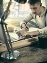 Portrait of a bearded businessman who is checking details of his upcoming meeting in his notebook and typing. Royalty Free Stock Photo