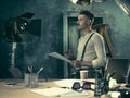 Portrait of a bearded businessman who is checking details of his upcoming meeting in his notebook and typing. Royalty Free Stock Photo