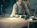 Portrait of a bearded businessman who is checking details of his upcoming meeting in his notebook and typing. Royalty Free Stock Photo