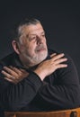 Portrait of bearded Caucasian man meditating in darkness