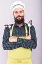 Portrait of a bearded chef holding two big kitchen utensils, lad