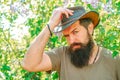 Portrait of bearded farmer in cowboy hat. Farmer working on spring field. Bearded Farmer on farmland.