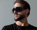 portrait of bearded fashion man with cool glasses looking to side