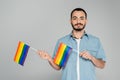 Portrait of bearded gay man holding