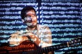 Portrait of the bearded guitar player with projection of the notes. Manis holding his guitar and looking into the camera