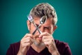 A portrait of bearded man holding spoon and fork in hands. People and food concept