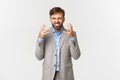 Portrait of bearded male employee in grey suit, complaining and shaking hands, looking angry, hate work, standing over