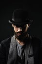 The portrait of bearded man in a bowler hat