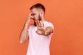 Man grabbing nose, grimacing in disgust and showing stop gesture, expressing repulsion to stink. Royalty Free Stock Photo