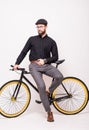 Portrait of a bearded man leaning on fixie bicycle over white background