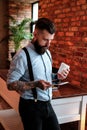 Portrait of bearded man with tattoes on his arms