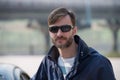 Portrait of a bearded man wearing sunglasses in a park. Royalty Free Stock Photo