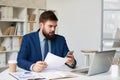 Frowning Businessman Working in Office