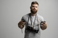 Portrait of bearded photographer with a bunch of different vintage old film cameras. Close up portrait of man holding Royalty Free Stock Photo