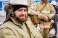 Portrait of bearded rescuer on summer day on street. Firefighter in protective uniform and helmet looks into camera and