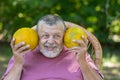 Portrait of a bearded senior farmer being happy with ripe melons Royalty Free Stock Photo