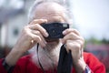 Portrait of bearded senior man photographer with old camera taking photo Royalty Free Stock Photo