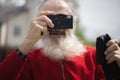 Portrait of bearded senior man photographer with old camera taking photo Royalty Free Stock Photo