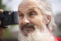 Portrait of bearded senior man photographer with old camera taking photo Royalty Free Stock Photo