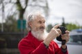 Portrait of bearded senior man photographer with old camera taking photo Royalty Free Stock Photo