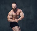 Portrait of bearded shirtless bodybuilder.