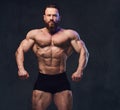 Portrait of bearded shirtless bodybuilder.