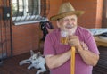 Portrait of bearded smiling senior man holding glass of tea Royalty Free Stock Photo