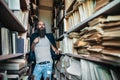 Portrait of bearded stylish hipster in library