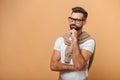 Portrait of bearded thoughtful handsome man with black glasses in casual style thinking and pondering. Studio shot on Royalty Free Stock Photo