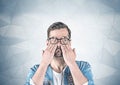 Casual man covering eyes with hands, gray wall Royalty Free Stock Photo