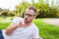 Portrait of bearded young man. Caucasian man smiling happy on sunny summer or spring day outside in park Royalty Free Stock Photo