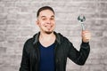 Portrait of bearded young man holding adjustable wrench on brick wall background Royalty Free Stock Photo