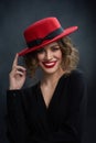 Portrait of wonderful girl touching red hat.