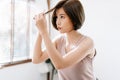 Portrait of beauiful young Asian woman having her hair cut with scissors at home. She`s stay at home during the coronavirus Royalty Free Stock Photo