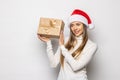 Portrait beautifiul caucasian woman in red Santa hat on white studio background. Christmas New Year holiday concept Surprised Cute Royalty Free Stock Photo