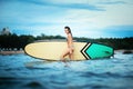 Portrait of beautiful active woman spending summer holidays on the beach, enjoying surfing, Bali, Indonesia Royalty Free Stock Photo