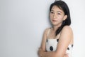 Portrait of beautiful adult 40 years old Asian woman in polka dots dress with arms crossed and pretending straight face over Royalty Free Stock Photo