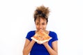 Beautiful african american girl eating slice of pizza against white background Royalty Free Stock Photo