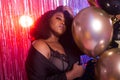 Portrait of a beautiful african american woman against twinkling background. Birthday party, nightclub and nightlife Royalty Free Stock Photo