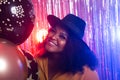 Portrait of a beautiful african american woman against twinkling background. Birthday party, nightclub and nightlife Royalty Free Stock Photo