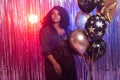 Portrait of a beautiful african american woman against twinkling background. Birthday party, nightclub and nightlife Royalty Free Stock Photo