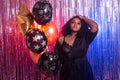 Portrait of a beautiful african american woman against twinkling background. Birthday party, nightclub and nightlife Royalty Free Stock Photo