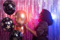 Portrait of a beautiful african american woman against twinkling background. Birthday party, nightclub and nightlife Royalty Free Stock Photo